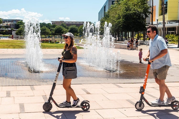 Couple Riding On E Scooters