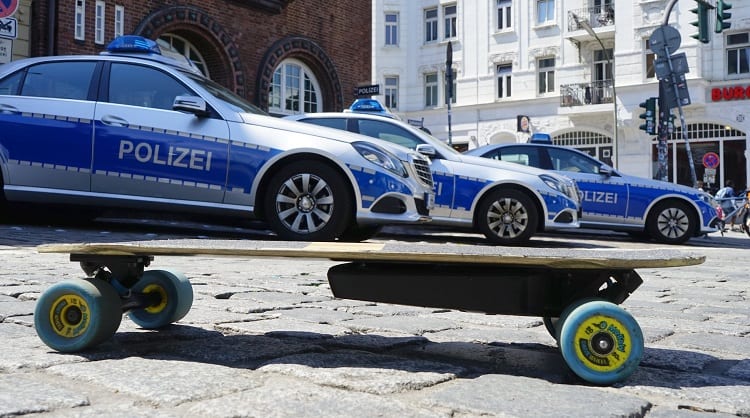 Electric Skateboard And Police Cars